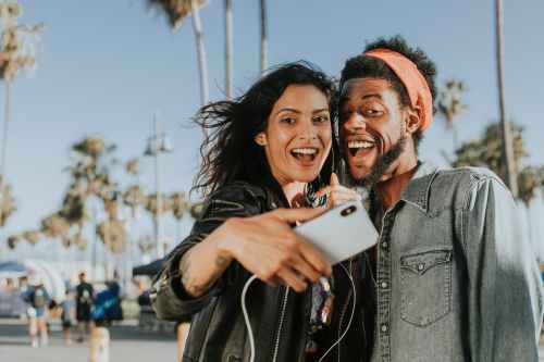 photo of man and woman taking selfie